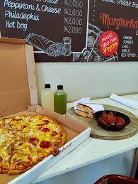 pizza in a box with ginger drink and chicken side